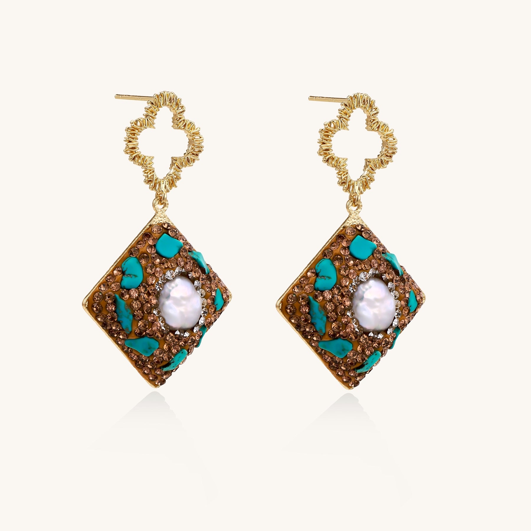 Gold quatrefoil stud earrings with ornate square pendants featuring turquoise stones and freshwater pearls