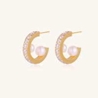 Gold-plated hoop earrings with crystal pavé and floating freshwater pearls inside the circular design.