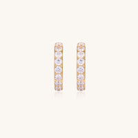Gold-plated hoop earrings with crystal pavé and floating freshwater pearls inside the circular design.