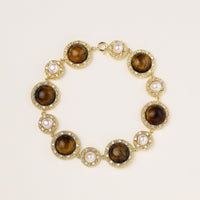 Ornate gold-plated bracelet with alternating brown tiger's eye stones and white freshwater pearls in crystal-accented settings