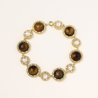 Ornate gold-plated bracelet with alternating brown tiger's eye stones and white freshwater pearls in crystal-accented settings