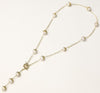 Long gold-plated lariat necklace featuring baroque pearls with metal caps arranged in elegant Y-shape design