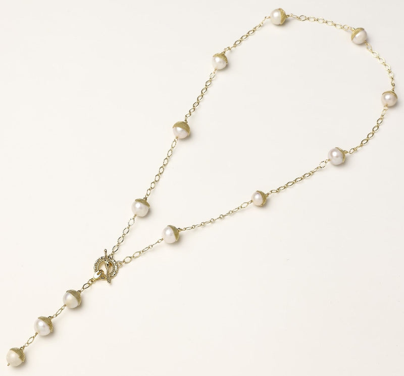 Long gold-plated lariat necklace featuring baroque pearls with metal caps arranged in elegant Y-shape design