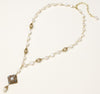 Elegant 14K gold plated necklace with freshwater pearls and ornate crystal diamond pendant on cream background.