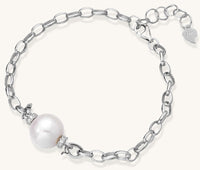 Dainty sterling silver chain bracelet with round freshwater pearl and crystal accents on white background.