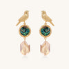 Gold-plated bird dangle earrings with iridescent abalone shell discs and champagne crystal drops on white background.