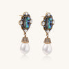Gold-plated brass drop earrings featuring iridescent abalone shell centers, crystal accents, and white pearl drops.