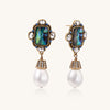 Gold-plated brass drop earrings featuring iridescent abalone shell centers, crystal accents, and white pearl drops.