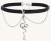 Black leather choker with gold-plated serpent pendant and crystal droplet on white background, adjustable chain design