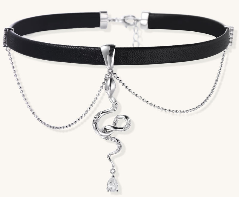 Black leather choker with gold-plated serpent pendant and crystal droplet on white background, adjustable chain design