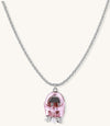 Delicate gold-plated chain necklace with transparent pink-tinted capsule pendant containing decorative bow element