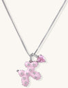 Pink enamel cross pendant with zirconia crystals and teardrop charm on 18K gold-plated chain against white background