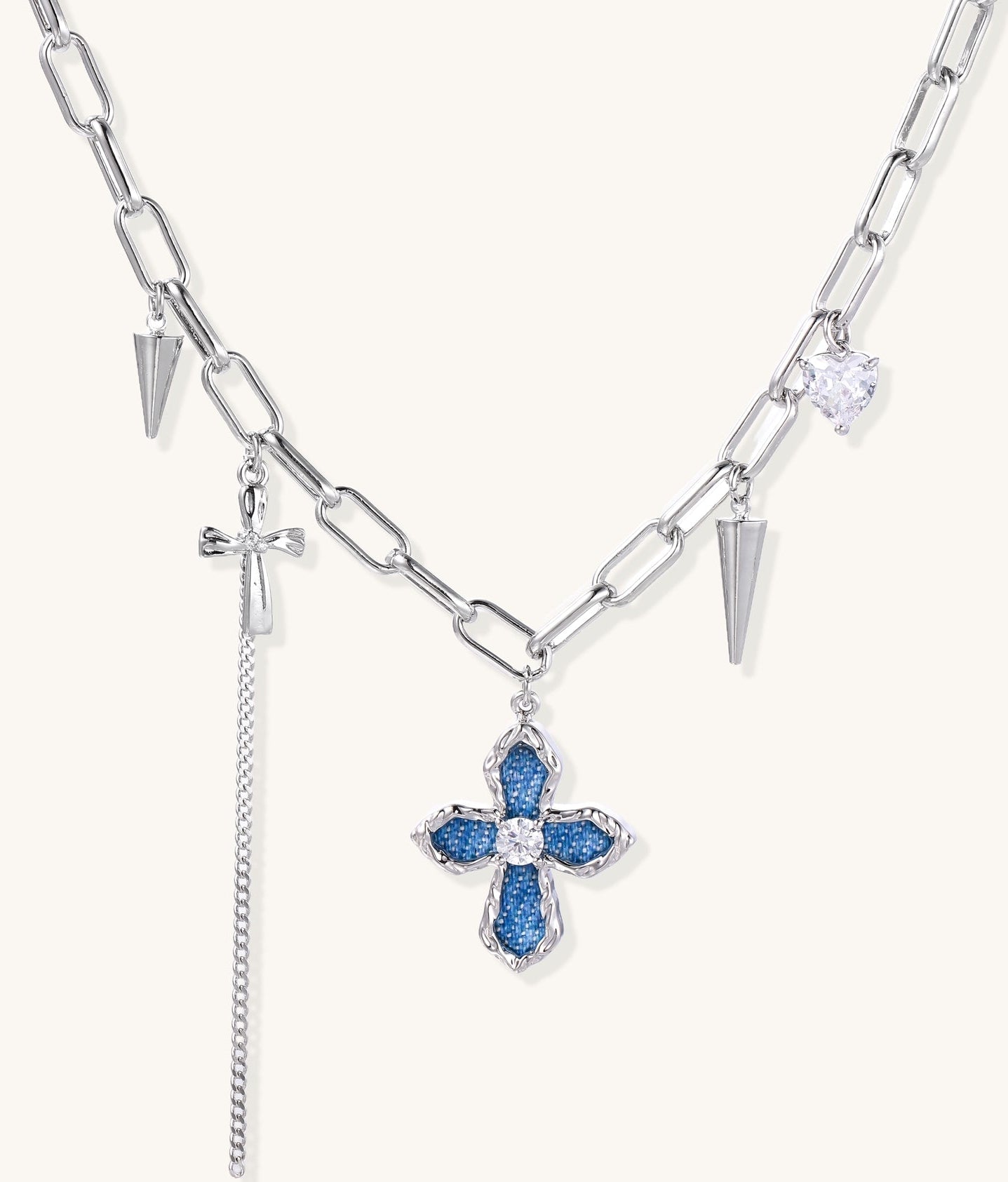 18K gold plated brass chain necklace featuring blue cross pendant with zirconia center stone and spike charms on white background.