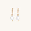 18K gold plated hoop earrings with freshwater pearl drops on neutral background, showing elegant minimalist design.