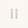 Gold-plated hoop earrings with crystal pavé and floating freshwater pearls inside the circular design.
