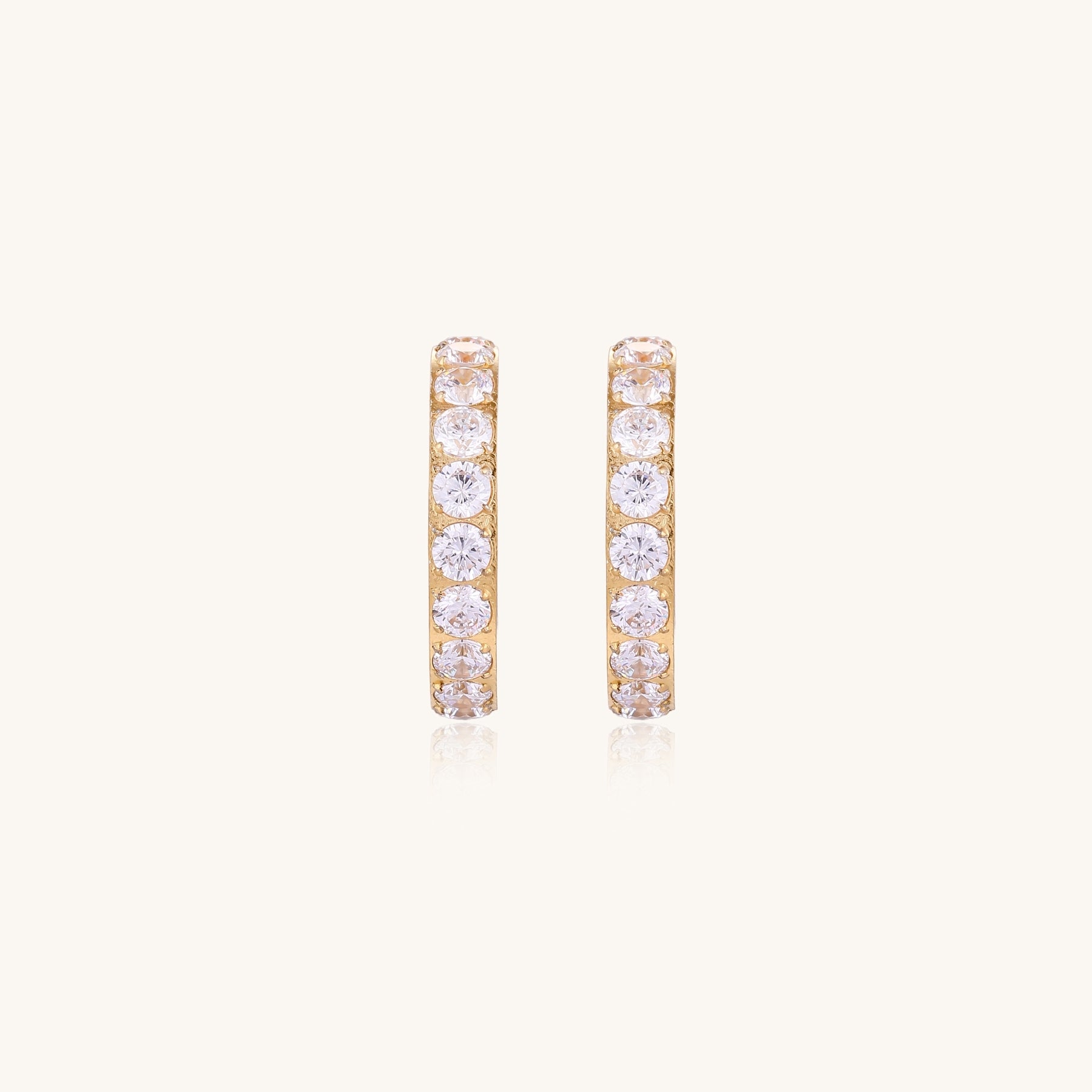 Gold-plated hoop earrings with crystal pavé and floating freshwater pearls inside the circular design.