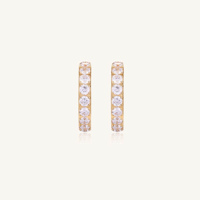 Gold-plated hoop earrings with crystal pavé and floating freshwater pearls inside the circular design.