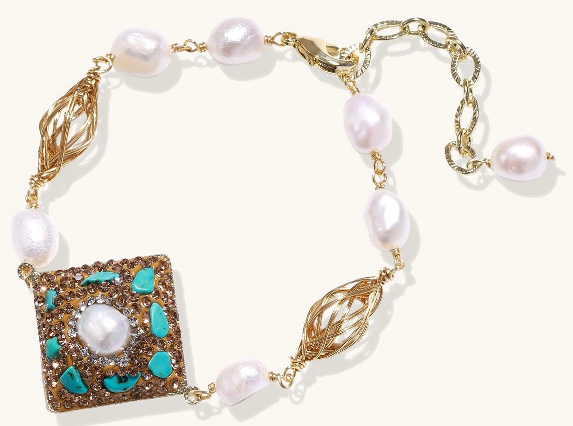Ornate gold-plated bracelet with square turquoise and crystal centerpiece, freshwater pearls, and decorative chain links