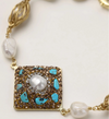 Ornate gold-plated bracelet with square turquoise and crystal centerpiece, freshwater pearls, and decorative chain links