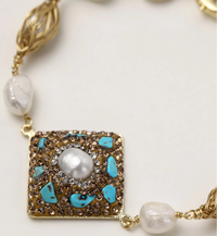 Ornate gold-plated bracelet with square turquoise and crystal centerpiece, freshwater pearls, and decorative chain links