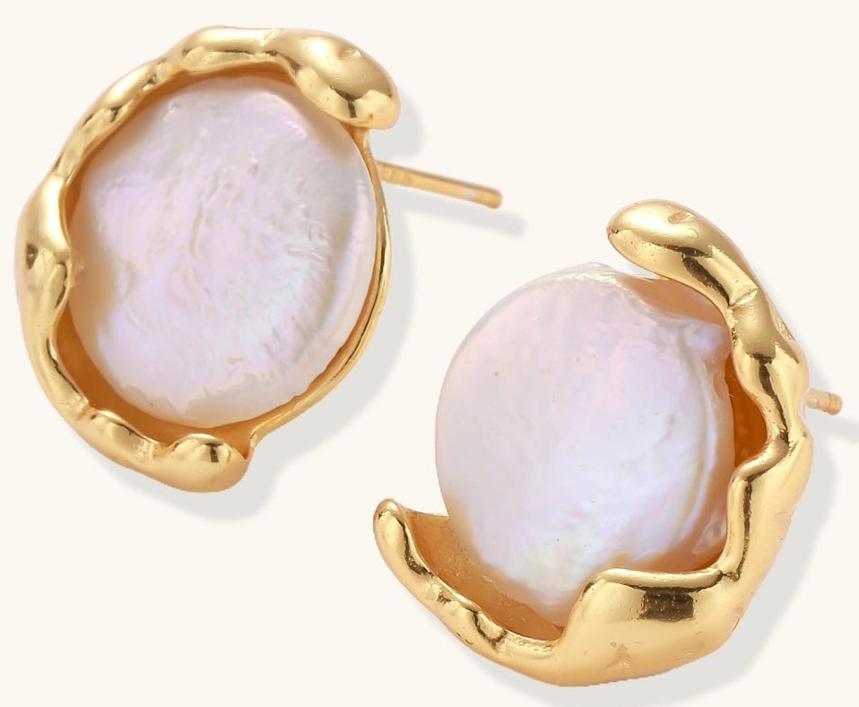 Gold-plated sterling silver stud earrings with organic claw settings cradling lustrous freshwater pearls on white background.