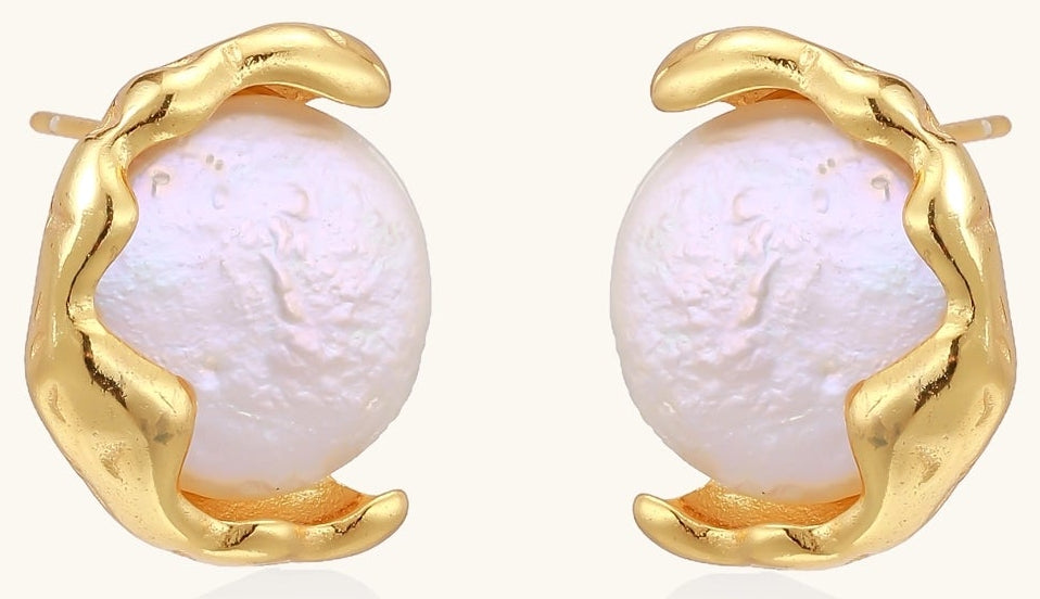 Gold-plated sterling silver stud earrings with organic claw settings cradling lustrous freshwater pearls on white background.