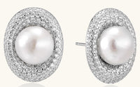 Sterling silver stud earrings with freshwater pearls surrounded by sparkling pavé crystals on white background.
