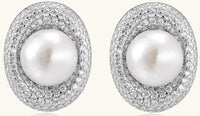 Sterling silver stud earrings with freshwater pearls surrounded by sparkling pavé crystals on white background.