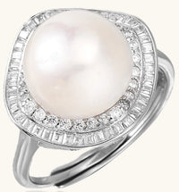 Sterling silver ring with 11mm freshwater pearl surrounded by double diamond halo on white background.