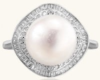 Sterling silver ring with 11mm freshwater pearl surrounded by double diamond halo on white background.