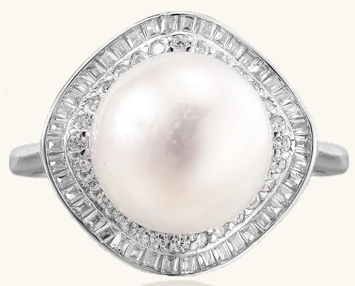 Sterling silver ring with 11mm freshwater pearl surrounded by double diamond halo on white background.