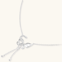 Delicate sterling silver butterfly pendant necklace with textured wing details and adjustable chain on white background