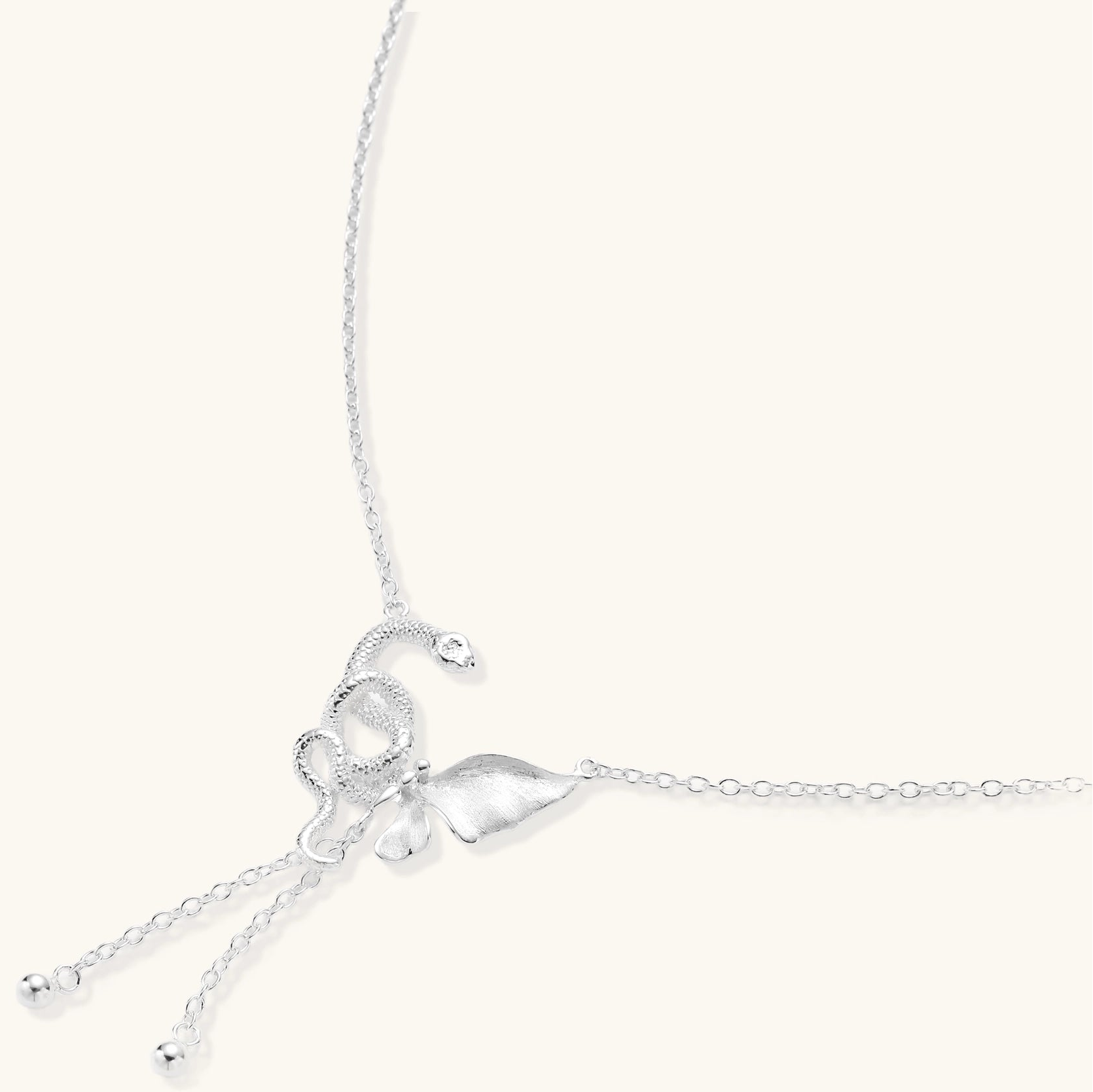 Delicate sterling silver butterfly pendant necklace with textured wing details and adjustable chain on white background