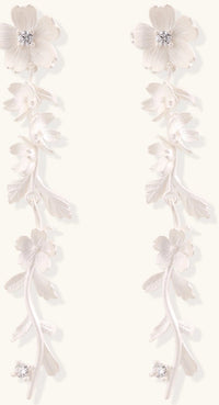 Pair of sterling silver dangle earrings with intricate leaf vine patterns and crystal accents on white background.