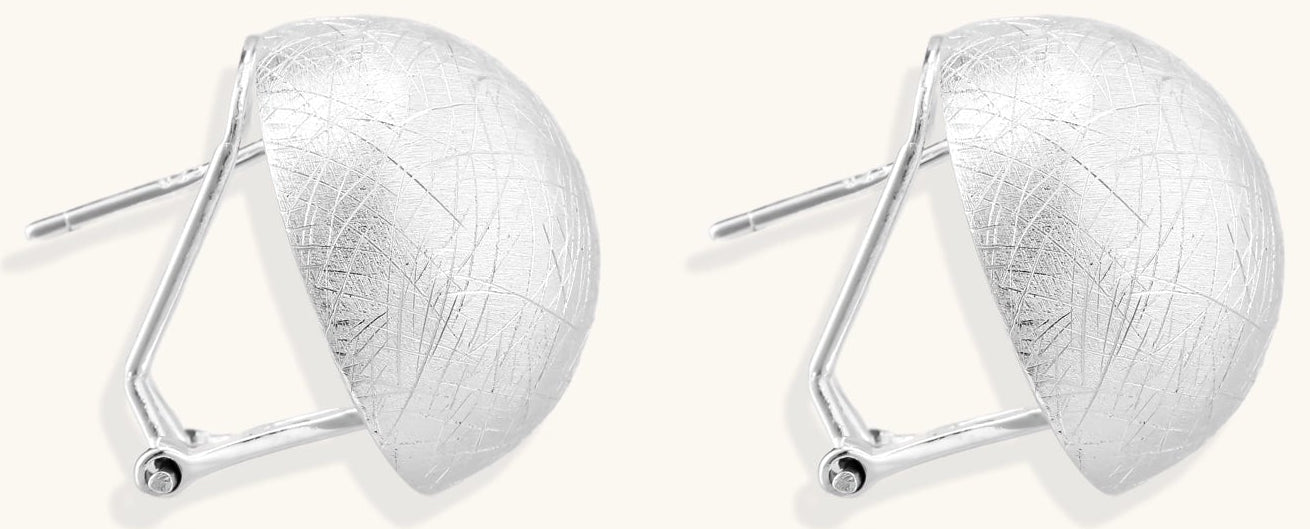 Brushed sterling silver dome-shaped stud earrings with textured surface and secure lever-back closure on white background.