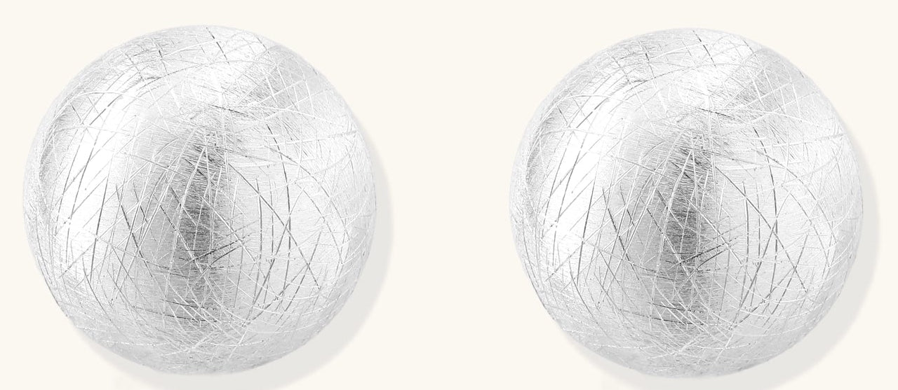 Brushed sterling silver dome-shaped stud earrings with textured surface and secure lever-back closure on white background.