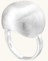 Minimalist sterling silver ring with large brushed disc top and adjustable band on white background.