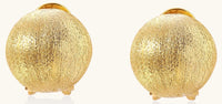 Close-up of textured gold-plated sterling silver dome clip-on earrings with brushed finish on white background.
