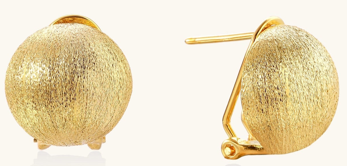 Close-up of textured gold-plated sterling silver dome clip-on earrings with brushed finish on white background.