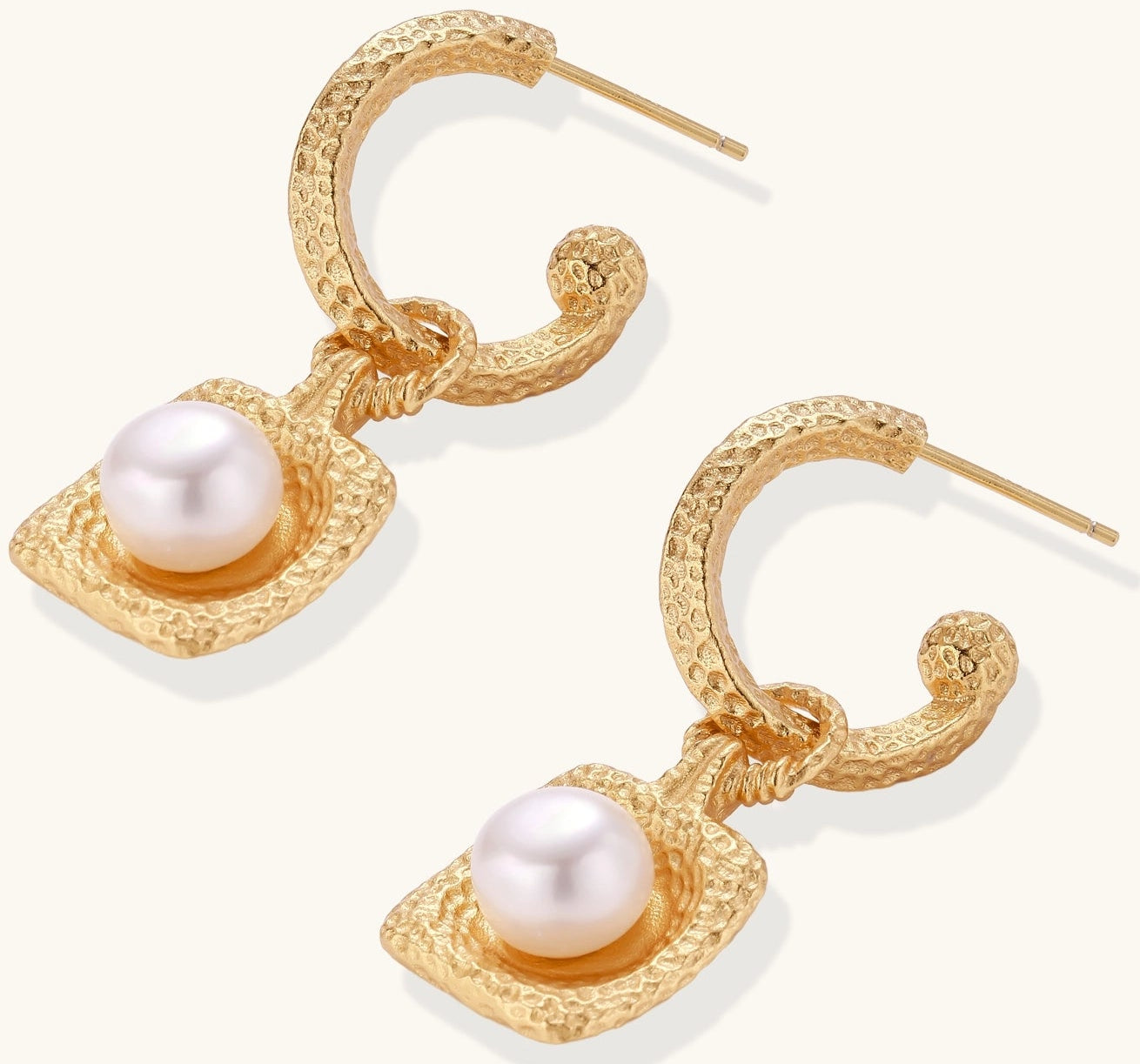 Gold-plated textured hoop earrings with square pendants containing freshwater pearls on white background