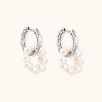 Rhodium-plated silver hoop earrings with freshwater pearls arranged in crescent formation and diamond accents