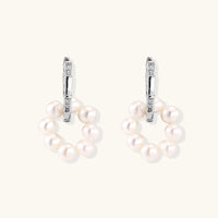 Rhodium-plated silver hoop earrings with freshwater pearls arranged in crescent formation and diamond accents