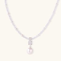 Dainty necklace with lavender crystal beads, freshwater pearls, geometric pendant, and large pearl drop on white background.