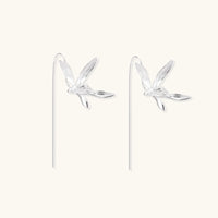 Delicate sterling silver dragonfly earrings with textured wings and curved threader hooks on white background
