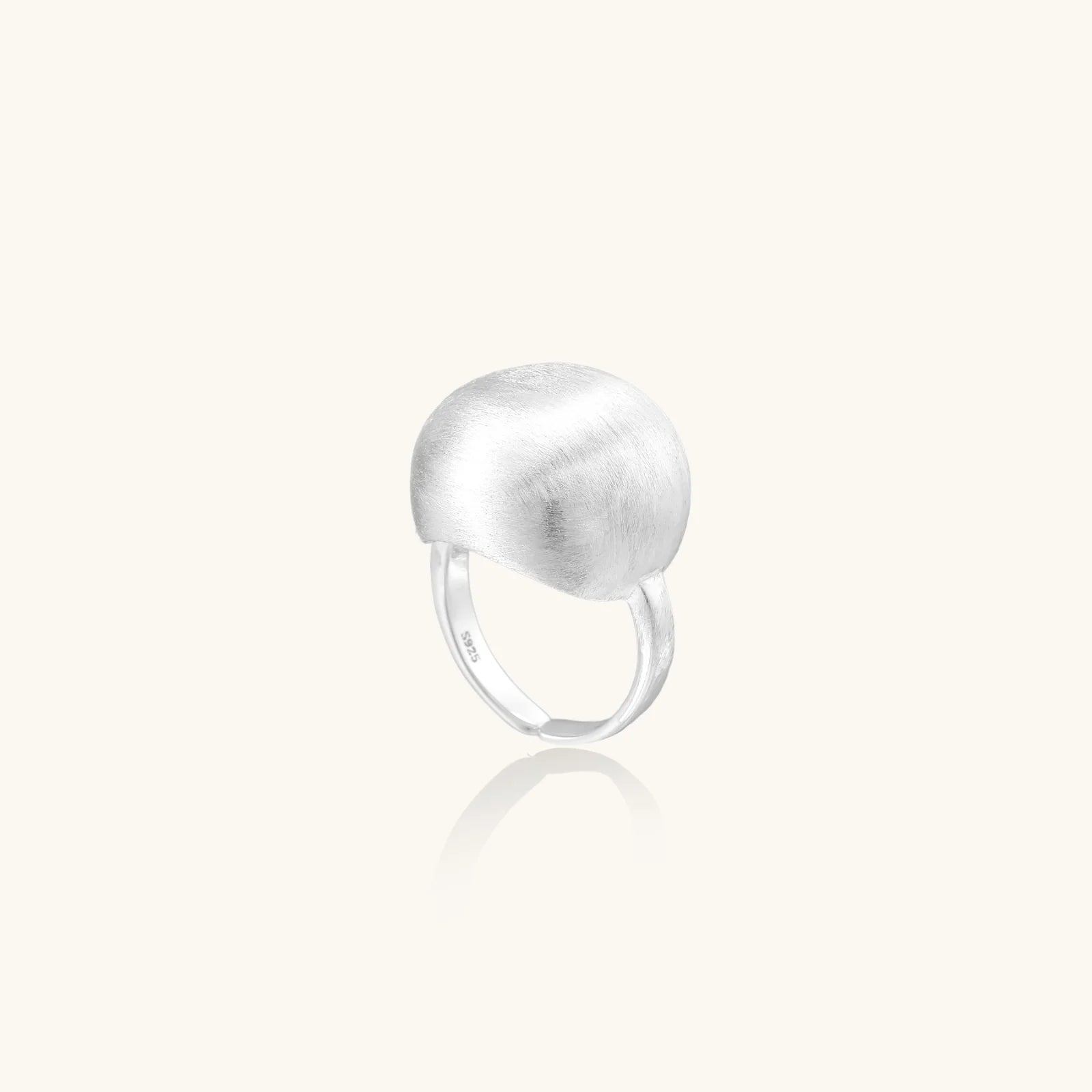 Minimalist brushed sterling silver dome ring with adjustable band on white background, front view.