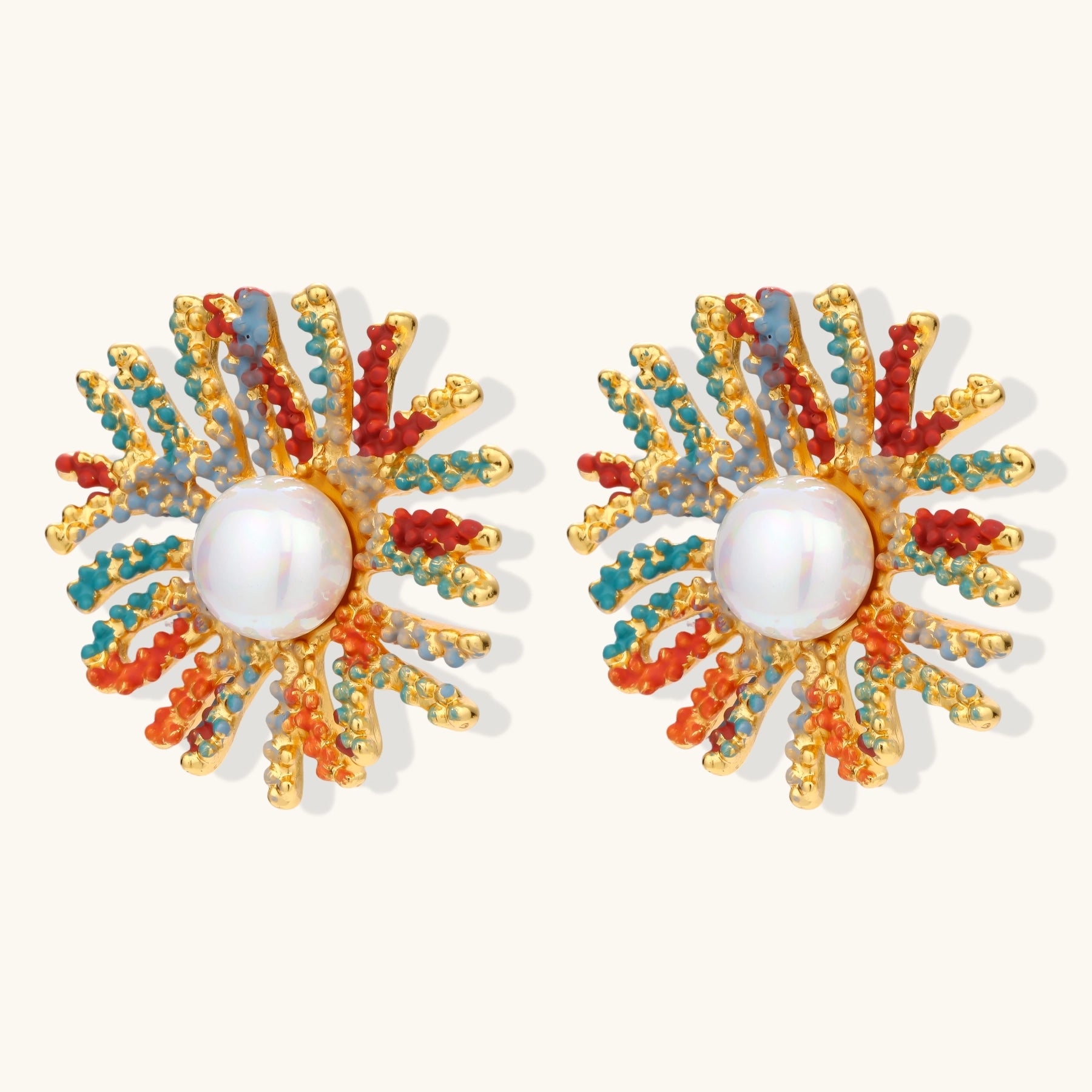 Vibrant starburst stud earrings with multicolor enamel rays and white pearl centers on gold-plated setting