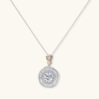 Sterling silver necklace with circular geometric pendant featuring central moissanite and radial baguette pattern.