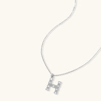 Letter H jewelry set featuring geometric crystal design in gold and white gold plated finish with adjustable chain necklace