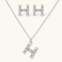 Letter H jewelry set featuring geometric crystal design in gold and white gold plated finish with adjustable chain necklace