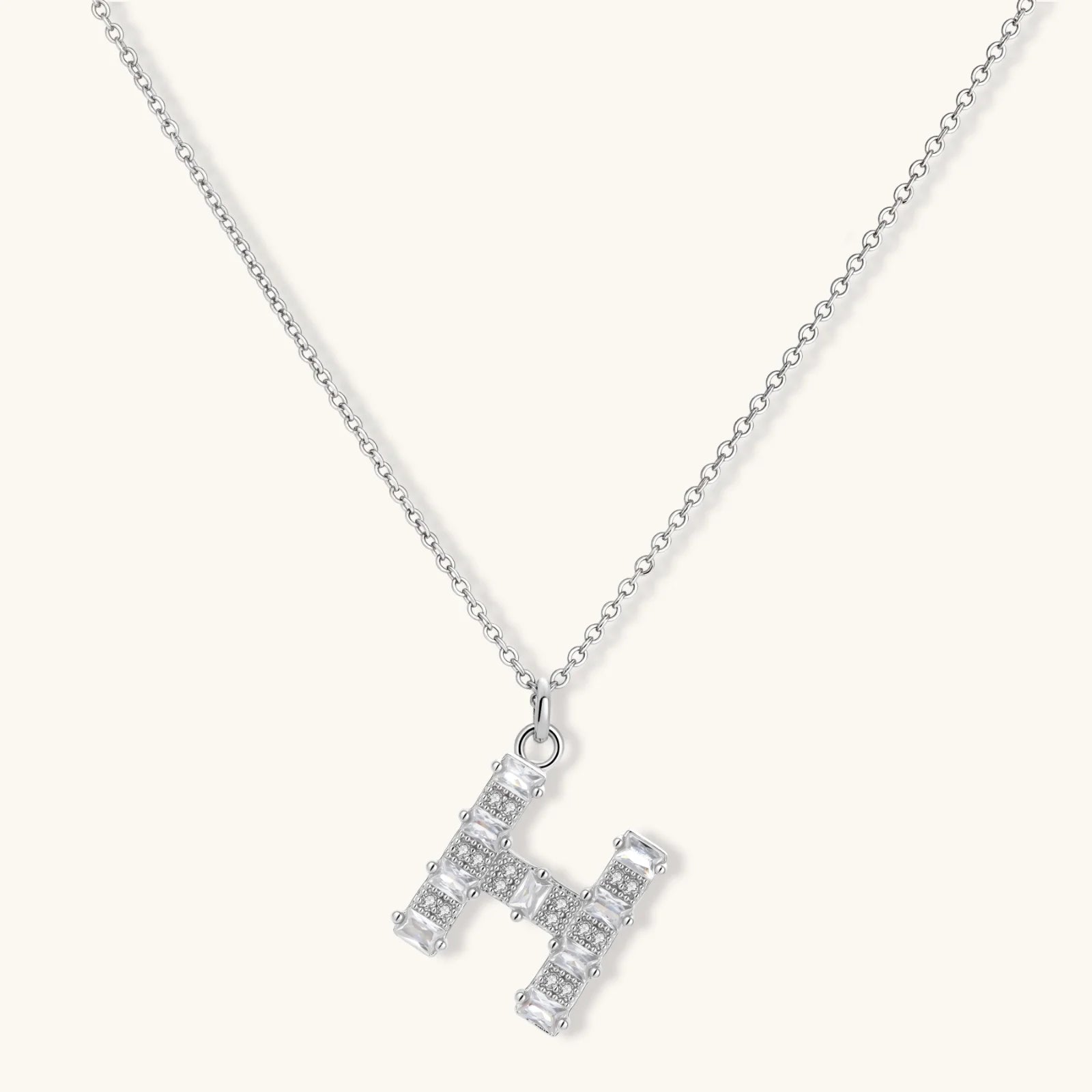 Letter H jewelry set featuring geometric crystal design in gold and white gold plated finish with adjustable chain necklace